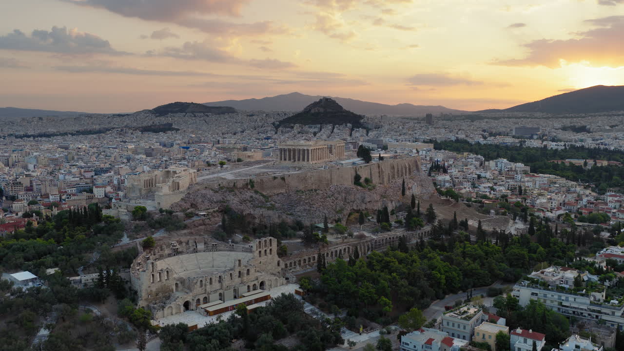 Acropolis of Athens temple monument, Parthenon and Odeon of Herodes Atticus amphitheatre with sunrise background, Athens, Drone shot, Panoramic view