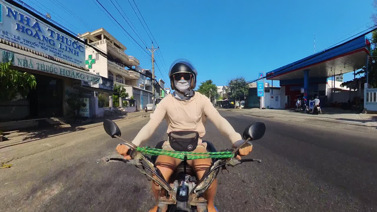 Man Riding A Motorbike On The Streets Of Asia. Forward Facing Action Shot POV.