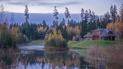 idyllic view of cottages by the lake during autumn of early morning