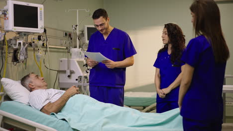medical staff attending to patient in hospital bed
