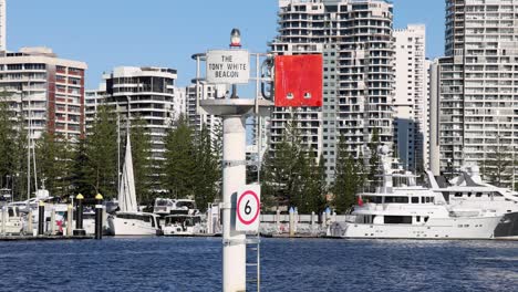 a boat navigates past a harbour marker