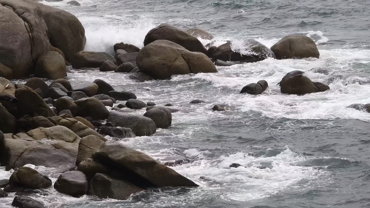 Waves Crashing Against Coastal Rocks