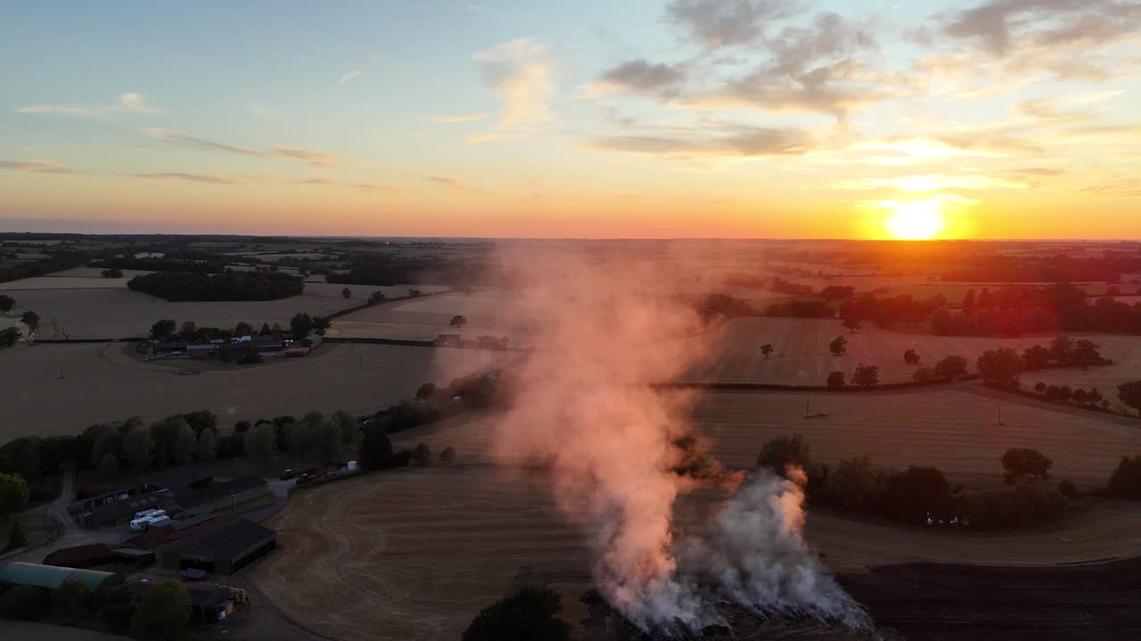 Sunset through smoke of farm field fire drone,aerial Essex UK