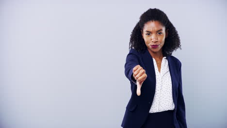 an-attractive-young-businesswoman-giving-thumbs-up