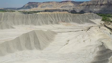 Aerial-View-of-Sandstone-Hills-and-Dry-Desert-Landscape-in-Utah,-Factory-Butte-Valley-Surroundings,-Wayne-County-USA