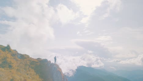 the man standing against the beautiful mountain landscape