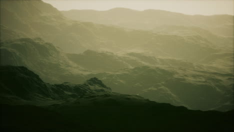 silhouette of swiss alps mountains in morning clouds