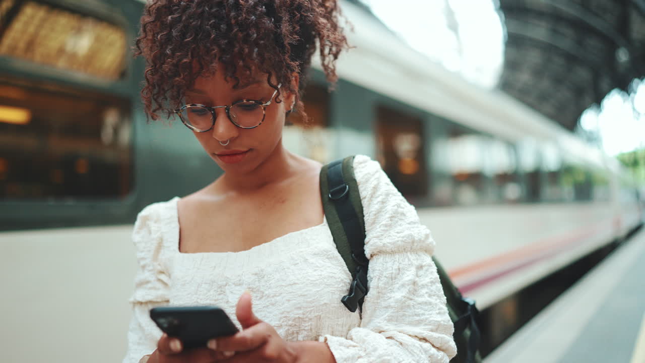 Woman using phone at train station