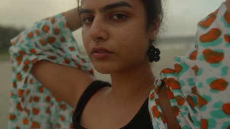 In-this-close-up-shot,-we-capture-the-beauty-of-an-Indian-woman-at-the-beach