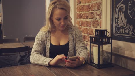 woman using smartphone at table