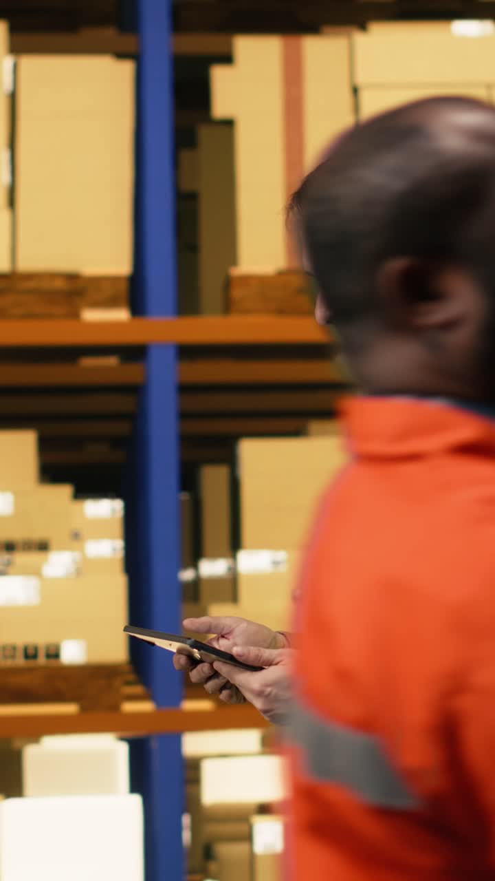 Vertical Video Male Personnel Operating With Laptop In E-Commerce Distribution Center