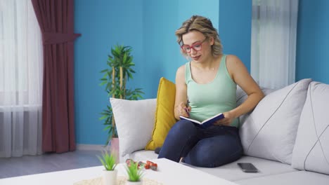 the woman keeping a diary at home. the woman writes a diary.