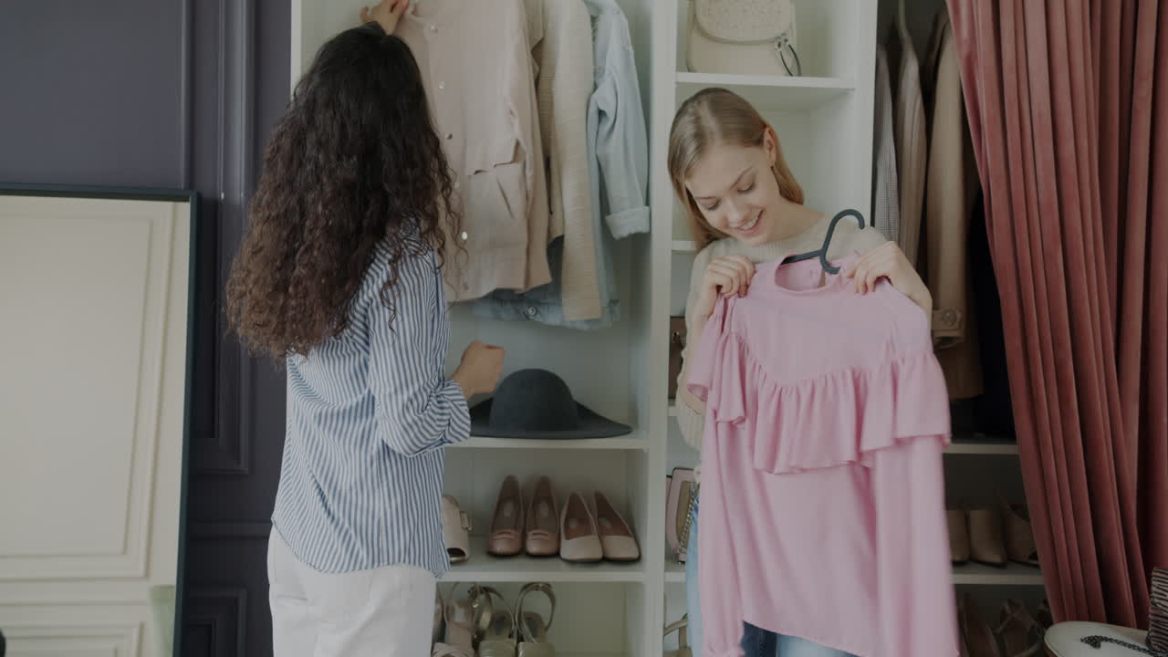 Women friends trying on clothes in a dressing room