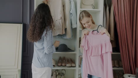 women friends trying on clothes in a dressing room