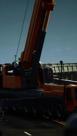 a large orange crane truck parked on the road