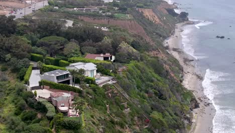 zuma beach by point dume and malibu mansions of the rich and famous - aerial parallax