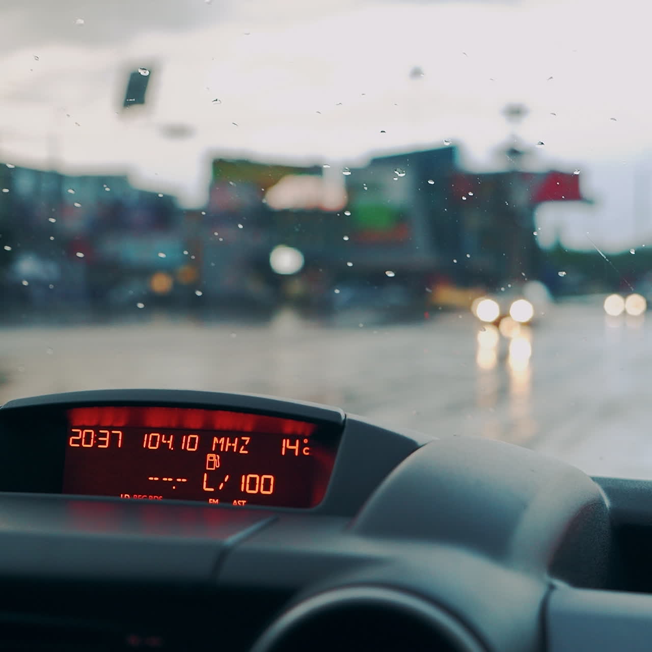 Control panel in the car close-up. Windscreen at the time of the rain.