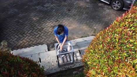 a-woman-was-washing-her-hands-in-the-sink-in-the-garden-of-the-house