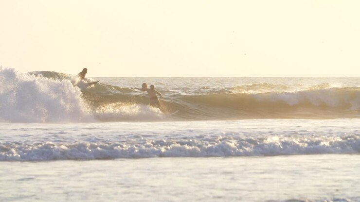 Slow Motion Shot of Surfers in the Ocean