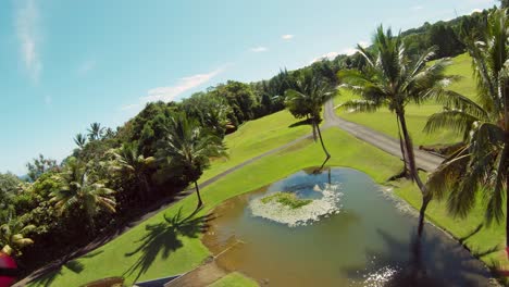 Top-down-aerial-view-of-a-luxurious-private-villa-on-the-side-of-a-cliff-surrounded-by-lush-green-foliage