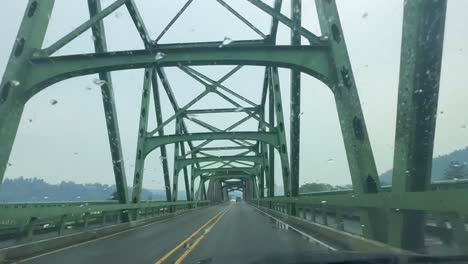 driving on umpqua river bridge on a rainy day in reedsport, oregon, usa