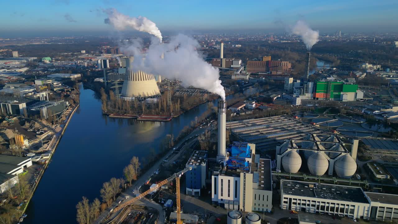 Industrial chimneys releasing large plumes of smoke pollution into the atmosphere, contributing to environmental damage. speed ramp hyper motion time lapse Perfect aerial view fly push forward drone