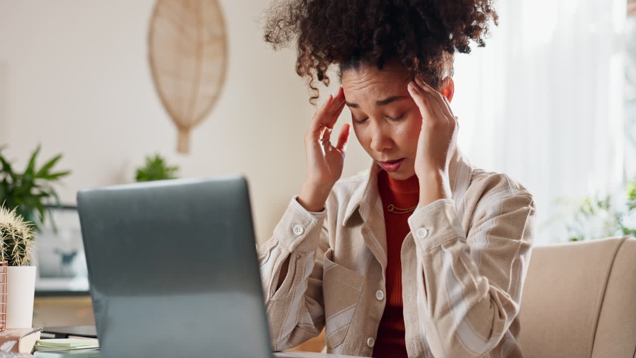 Woman Working on Laptop at Home