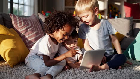 diverse children engrossed in a tablet at home