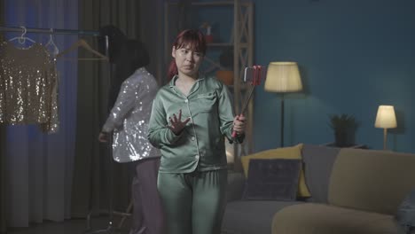 two women taking a selfie in pajamas