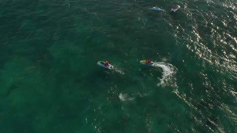 Jet-ski-rider-having-issues-with-his-watercraft.-Young-couple-on-jet-ski-trying-to-help-them.-Aerial-view