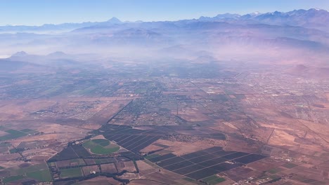 flying over rural areas of santiago de chile in an airplane at the end of summer before the first rains.