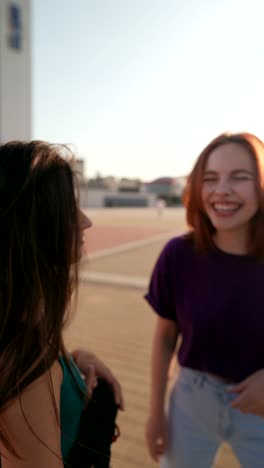 two young women talking outdoors