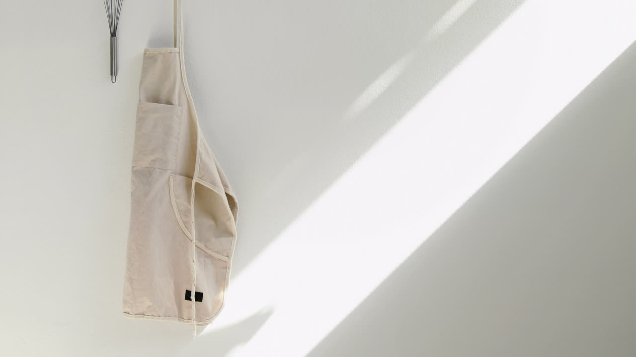 Apron and whisker hanging on hook 4k