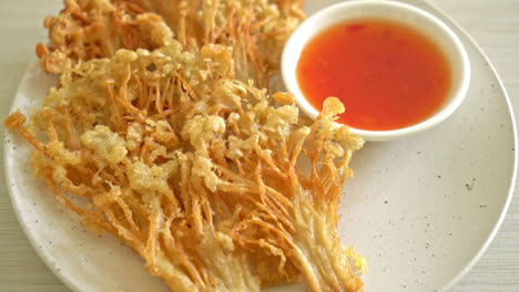 deep fried enoki mushroom or golden needle mushroom with spicy dipping sauce - vegan food style