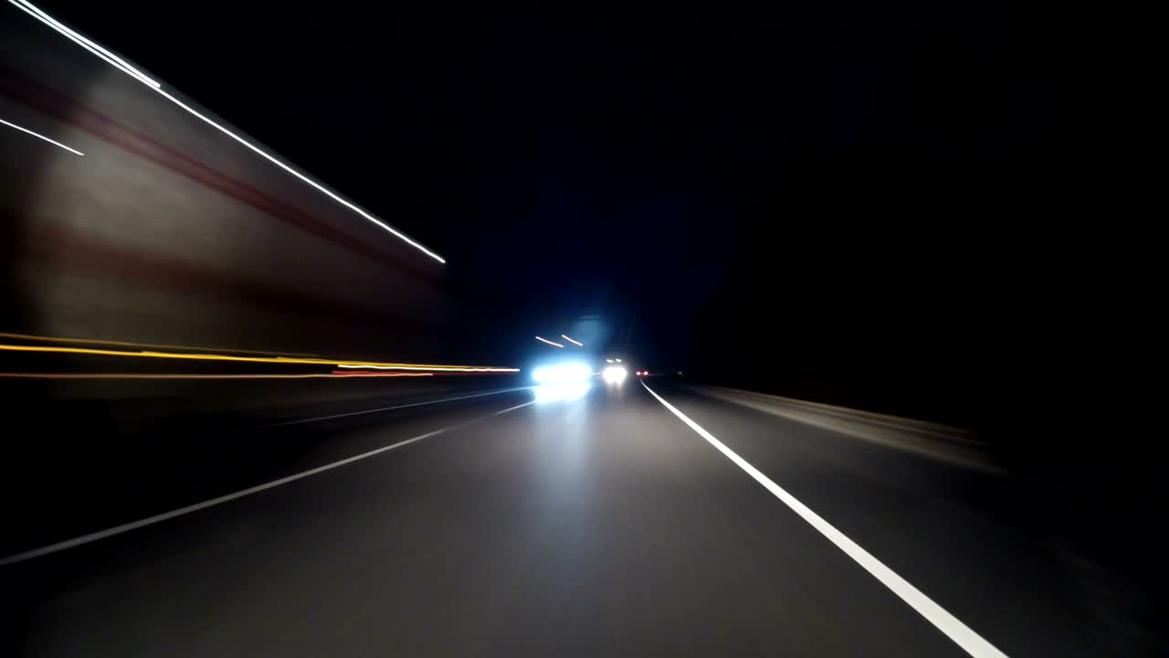 POV timelapse fast car drive old countryroad at night. Flow of oncoming trucks. Drive pov old road timelapse/hyperlapse night. Pov night driving hyperlapse at highway passing a series of tunnels. Camera is placed outside vehicle and level is horizontal