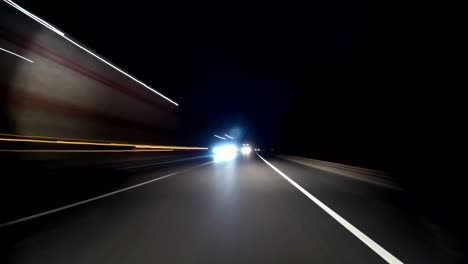 pov timelapse fast car drive old countryroad at night. flow of oncoming trucks. drive pov old road timelapse/hyperlapse night. pov night driving hyperlapse at highway passing a series of tunnels. camera is placed outside vehicle and level is horizontal