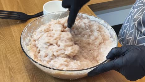mixing minced chicken for meatballs