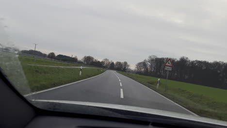 pop slow motion drive on rural german road during cloudy day