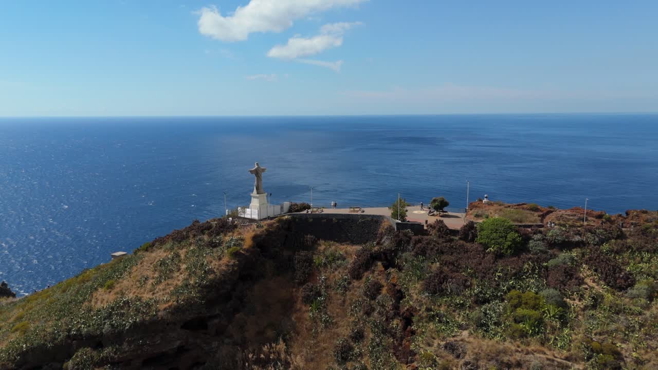 Drone shot orbiting Statue of Jesus Christ, Cristo Rei cultural landmark in Madeira