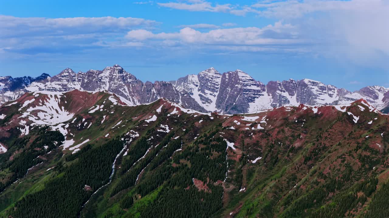 Summit of Pyramid Peak Maroon peak North Maroon Bells Wilderness aerial drone parallax upward Colorado pano Aspen Highlands bowl spring summer sunny morning blue sky clouds Rocky Elk Mountain Range