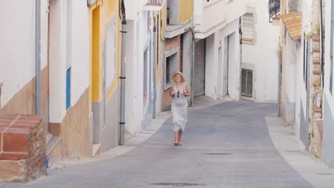 woman tourist is vverhpo narrow street in the old quarter of the old city lloret de mar spain touris