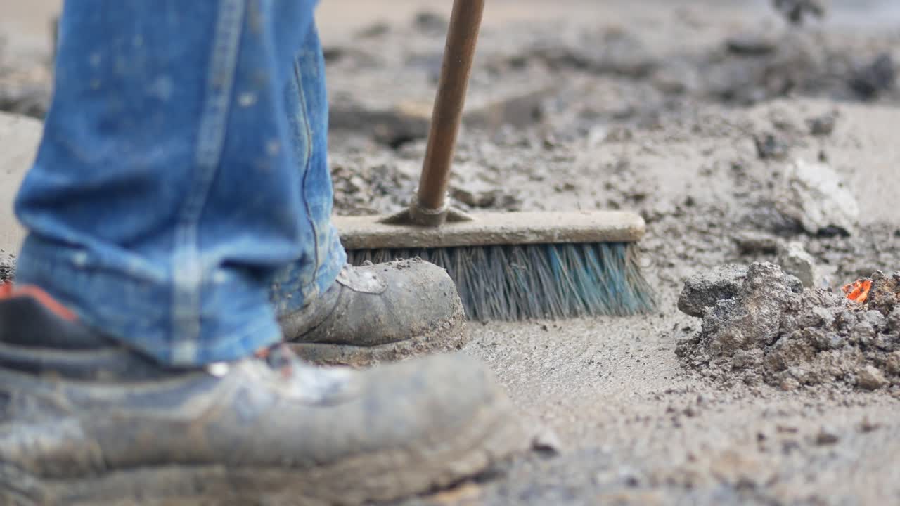 Construction Worker Sweeping Dirt