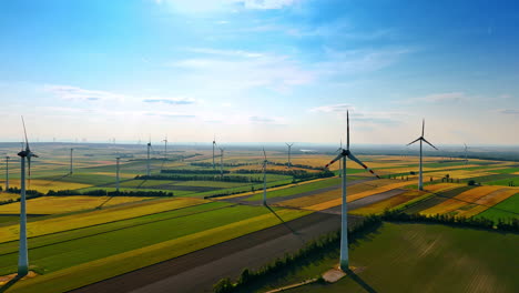 wind turbines in green fields. wind turbines rotate gracefully across vast green fields under a clear blue sky, highlighting renewable energy efforts