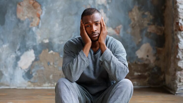 A contemplative individual sitting on the floor, expressing emotional turmoil and uncertainty through body language, showcasing a range of feelings from despair to questioning in a minimalist, textured environment