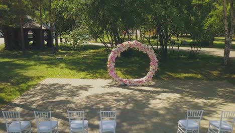 nice wedding venue with flowers and chairs in park aerial