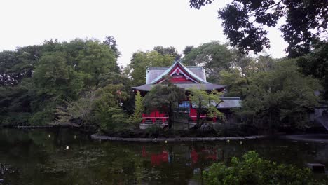 in kichijoji park, in tokyo, there is a beautiful red shinto temple