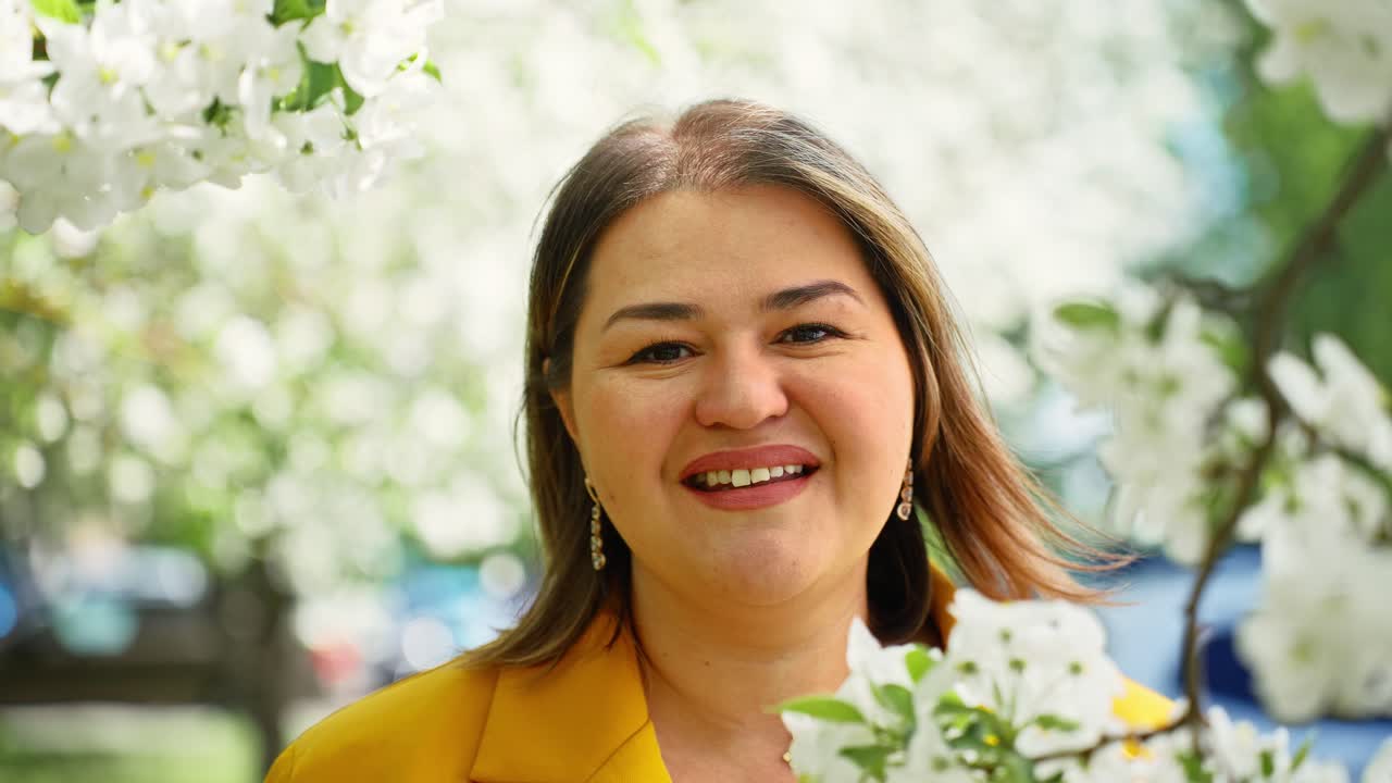 Woman smiling in a spring blossom