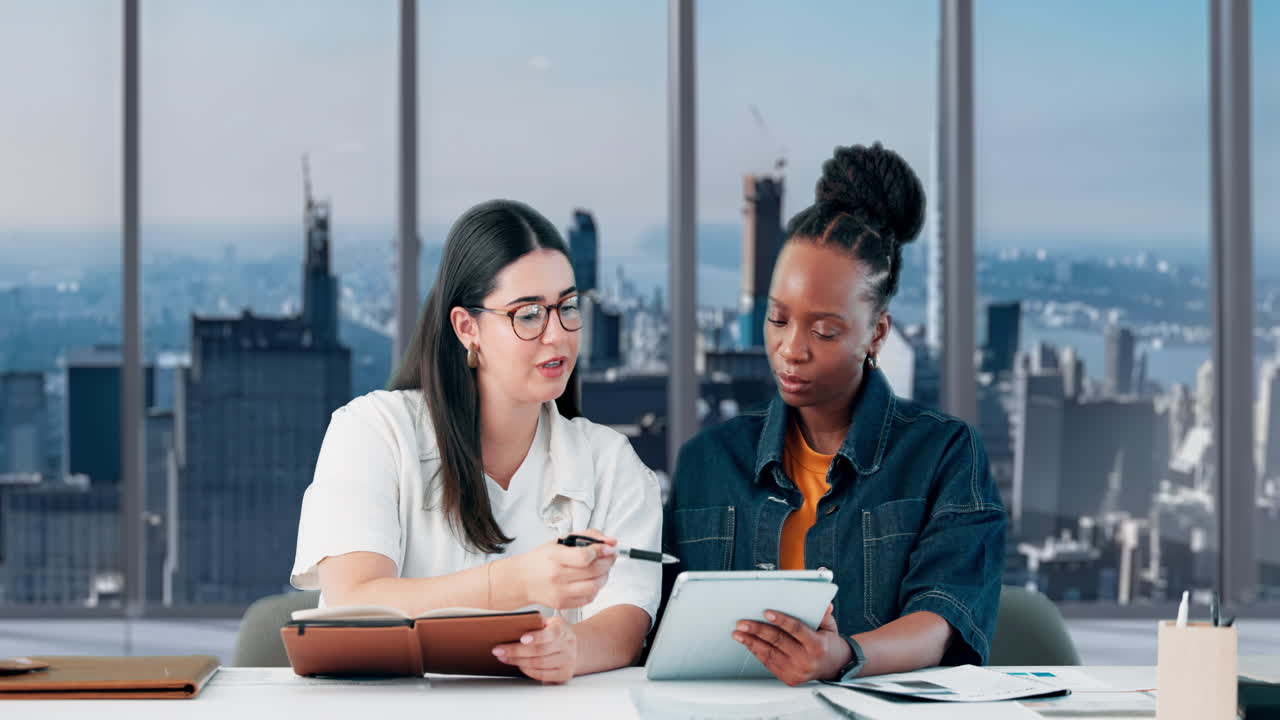 Two Diverse Businesswomen Collaborating in a Modern Office with City View