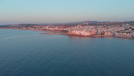 Drohnenansicht-Des-Sonnenuntergangs-Aus-Der-Luft-Der-Küste-Von-Sitges,-Spanien,-Reisehintergrund