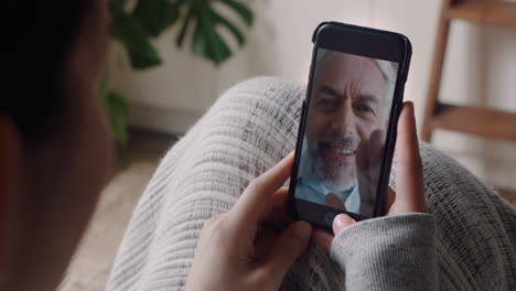 young-woman-having-video-chat-using-smartphone-chatting-to-grandfather-enjoying-conversation-sharing-lifestyle-communicating-with-mobile-phone-at-home